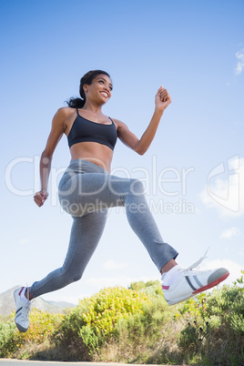 Fit woman running along the open road