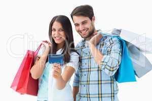 Attractive young couple with shopping bags and credit card