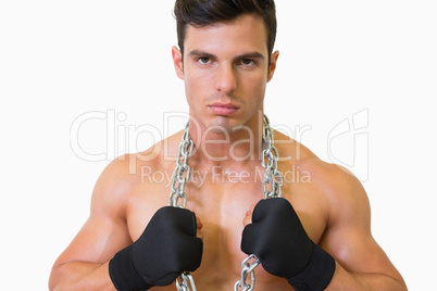 Portrait of a serious shirtless young muscular man