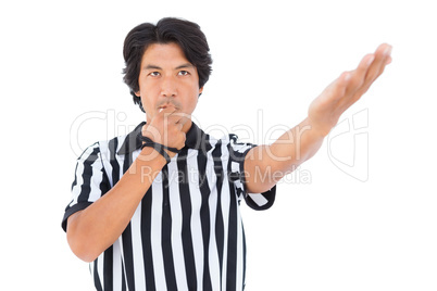 Stern referee blowing his whistle