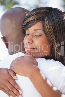 Attractive couple embracing in their garden