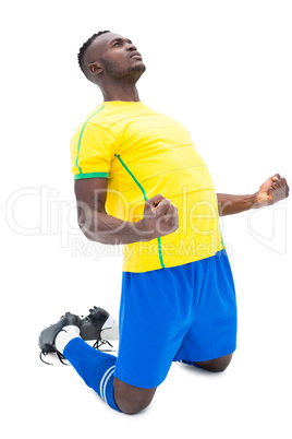 Football player in yellow celebrating a win