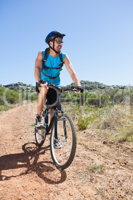 Fit cyclist riding in the countryside