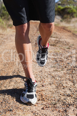 Athletic man jogging in the countryside