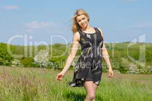 Pretty blonde in sundress smiling at camera