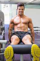 Muscular man doing a leg workout at gym