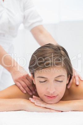 Attractive woman receiving shoulder massage at spa center