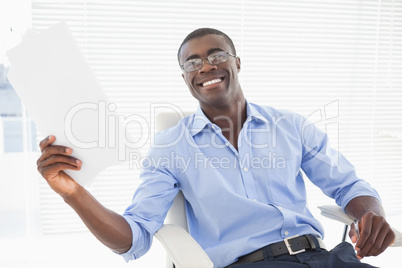 Happy businessman holding a page