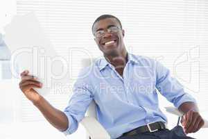 Happy businessman holding a page