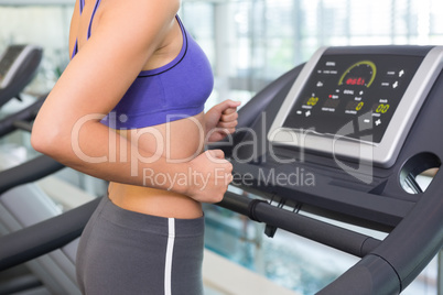 Fit woman running on the treadmill