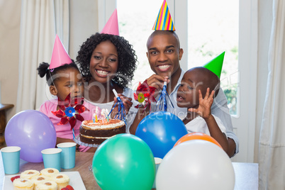 Happy family celebrating a birthday together at table