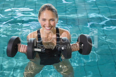 Fit blonde working out with foam dumbbells Fit blonde working out with foam dumbbells