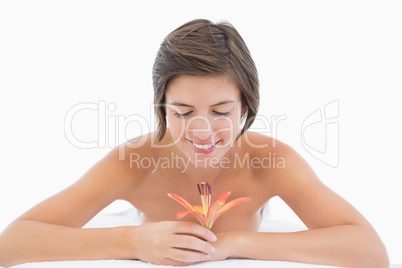 Close up portrait of a beautiful young woman holding flower