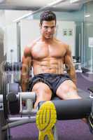 Muscular man doing a leg workout at the gym