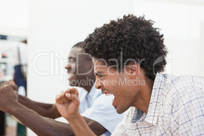 Football fans cheering in front of tv