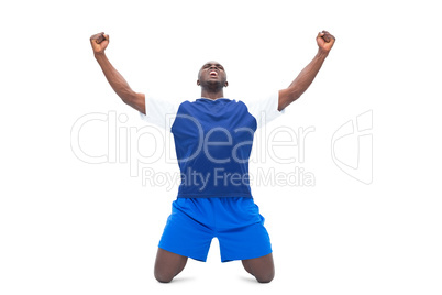 Football player in blue celebrating a win