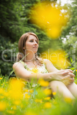 Cute young woman relaxing in field