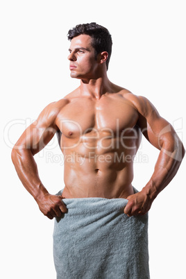 Shirtless muscular man wrapped in white towel