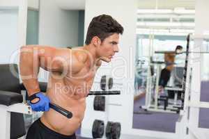 Determined muscular man doing crossfit fitness workout in gym