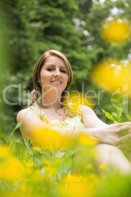 Cute young woman relaxing in field