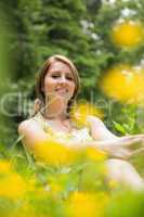 Cute young woman relaxing in field