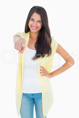 Happy casual woman pointing to camera