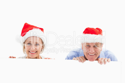 Festive mature couple smiling at camera