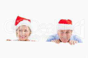 Festive mature couple smiling at camera