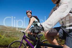 Active happy couple on a bike ride in the country