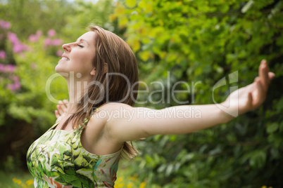 Woman with arms outstretched in field