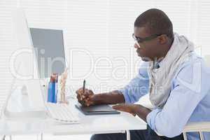 Hipster businessman working at his desk