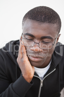 Casual man sitting on his sofa wearing glasses