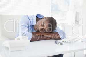 Tired businessman sleeping at his desk