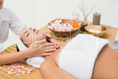 Peaceful brunette enjoying a neck massage