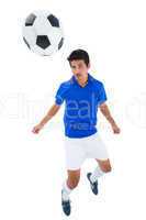 Football player in blue heading ball