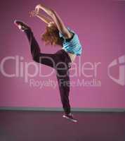 Pretty break dancer leaping mid air