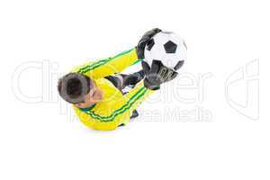 Goalkeeper in yellow holding ball