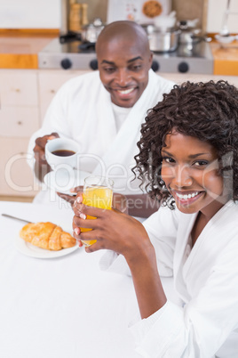 Happy couple having breakfast together at table