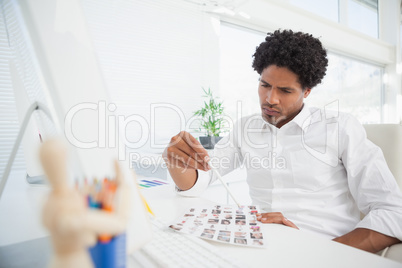 Hipster photo editor working at his desk