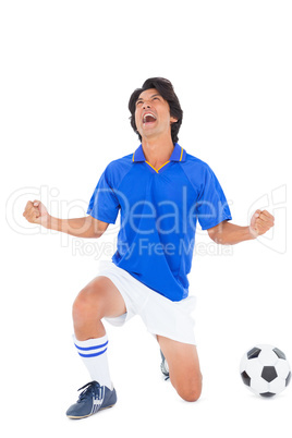 Football player in blue celebrating