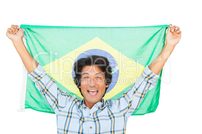 Football fan holding brazil flag and cheering