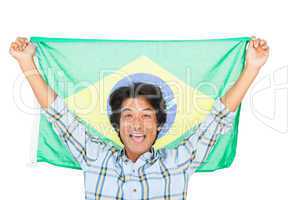 Football fan holding brazil flag and cheering