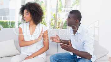 Attractive couple having an argument on couch