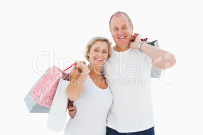 Smiling mature couple holding shopping bags