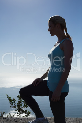 Fit woman standing looking out to sea