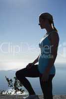 Fit woman standing looking out to sea