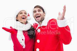 Attractive festive couple posing with hands up
