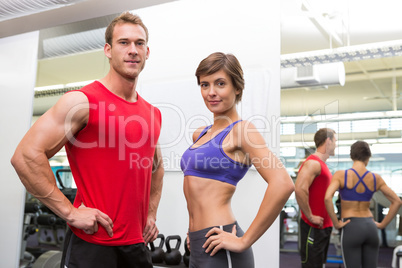 Fit attractive couple smiling at camera