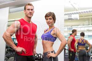 Fit attractive couple smiling at camera