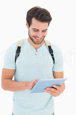 Handsome student using his tablet pc